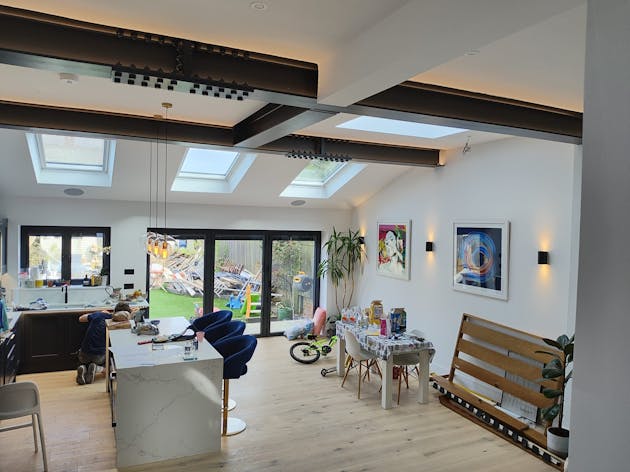Dimmable strip lighting on exposed beams overhead.